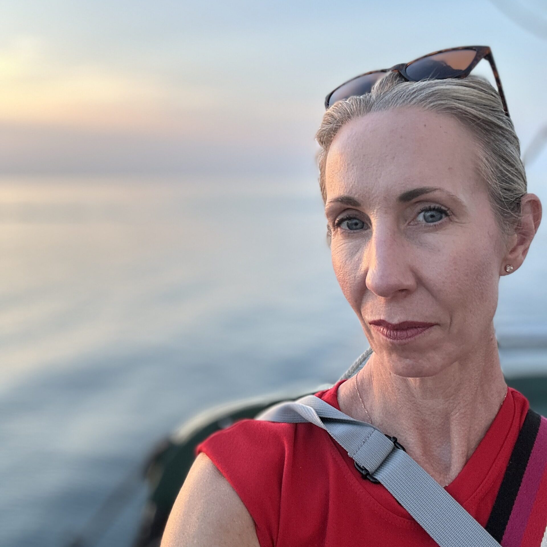 blonde woman selfie photo in front of clouds.